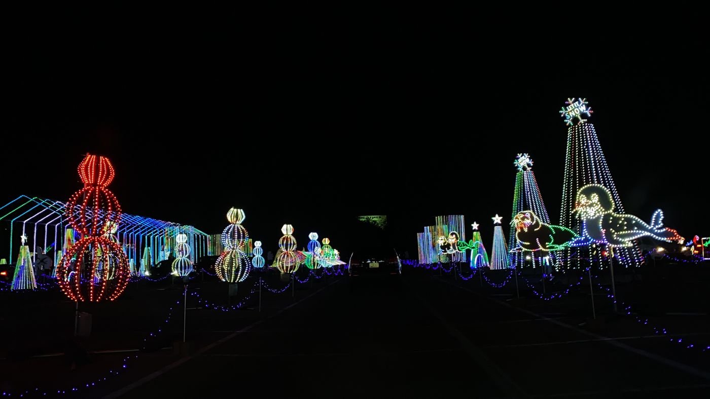 Drive-through holiday light display at night, with glowing animal and snowman figures along a road (illustrative photo, not Tanglewood itself)