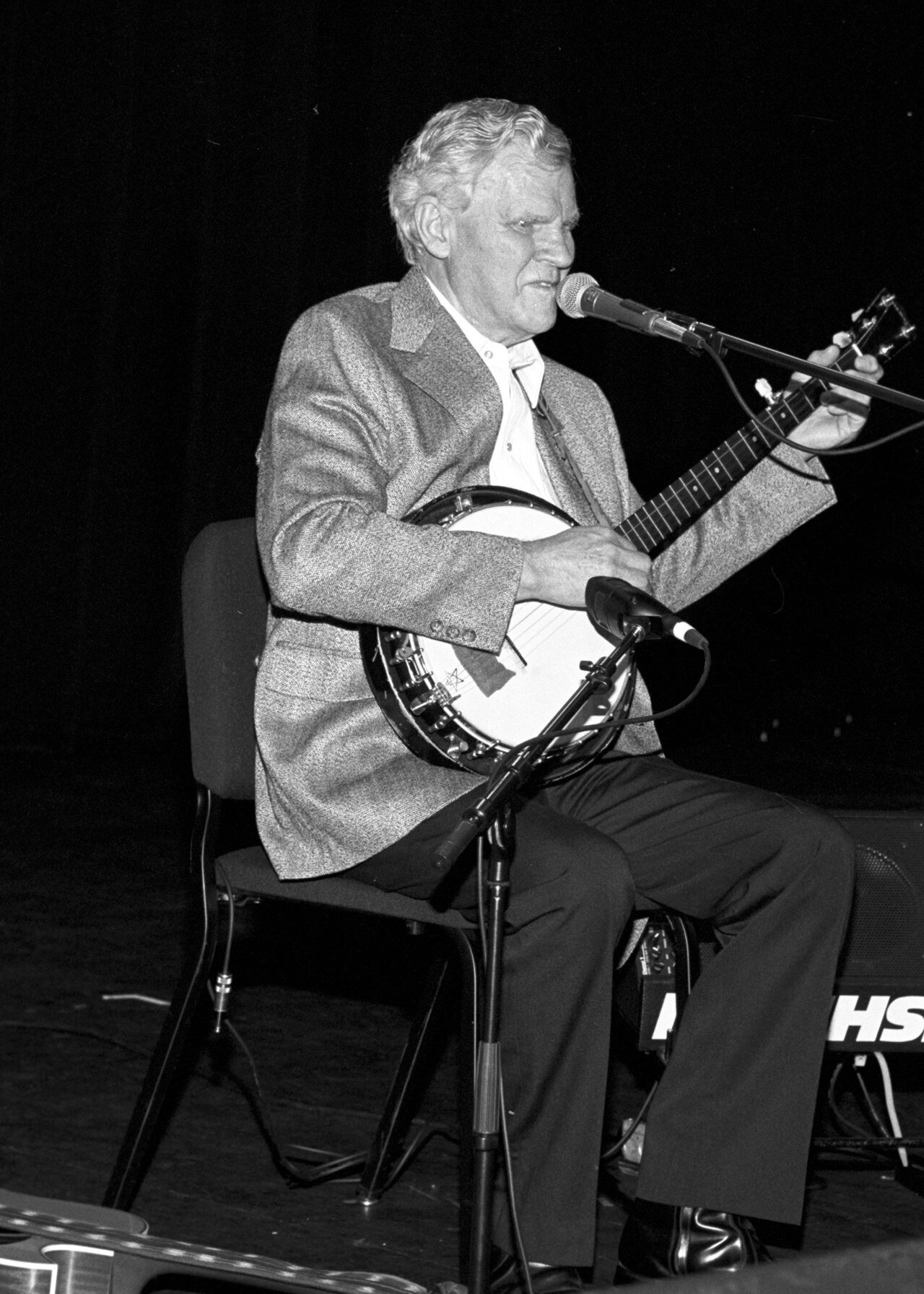 Doc Watson playing banjo on stage at the 1994 North Carolina Folk Heritage Awards