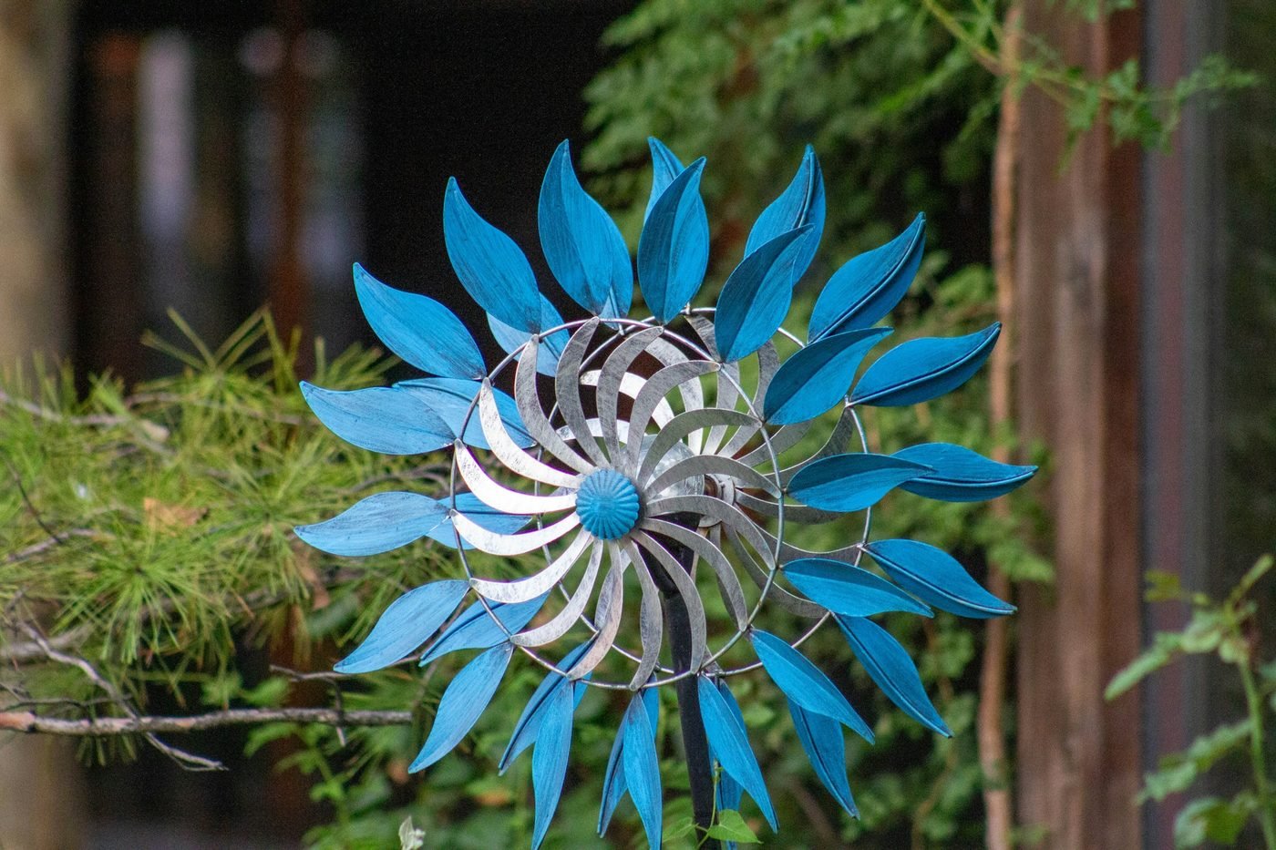 Blue metal garden wind spinner with leaf-shaped blades (illustrative photo by Samson Tarimo on Unsplash, not a Vollis Simpson whirligig)