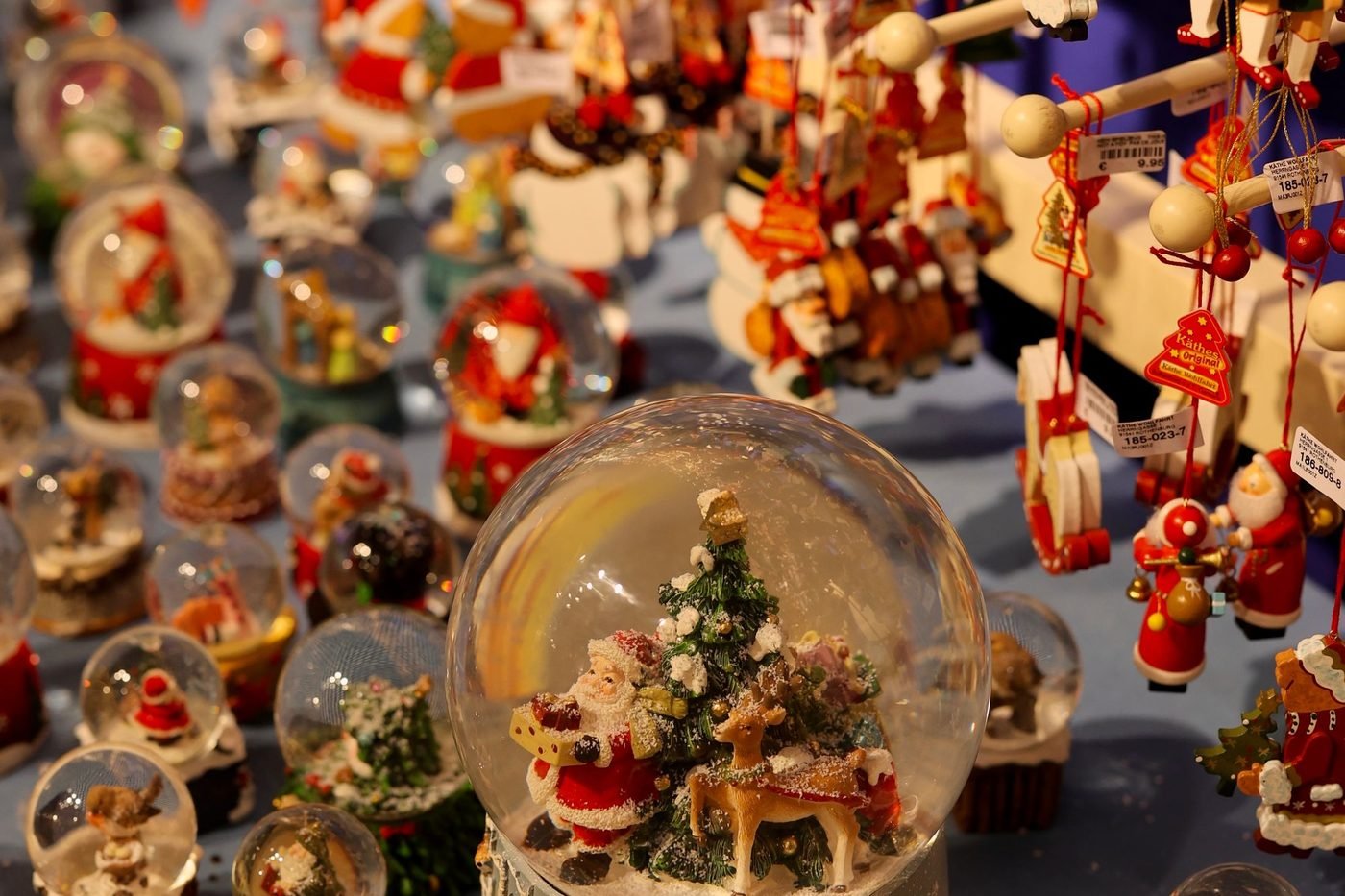 Snow globes and Santa ornaments on a holiday vendor table (illustrative photo by Nuray on Pexels, not a Southern Christmas Show booth)
